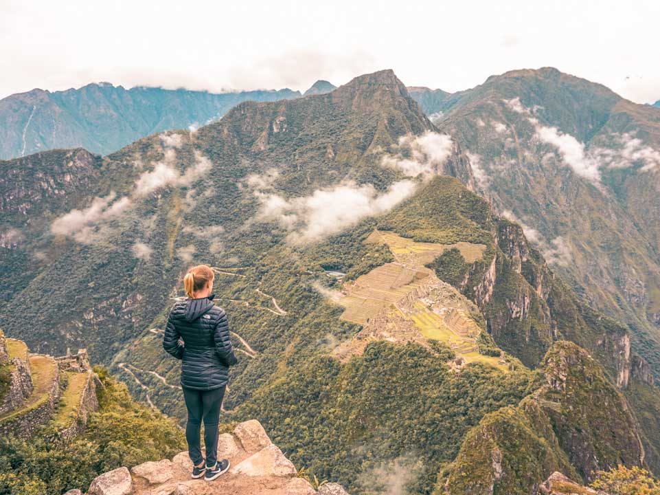 A female looking out at Machu Picchu from Huayna Picchu mountain