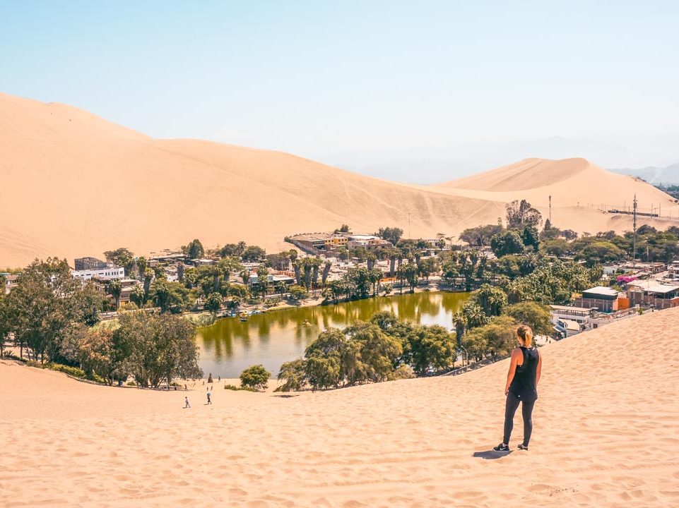 A female looking out at the oasis at Huacachina, Peru