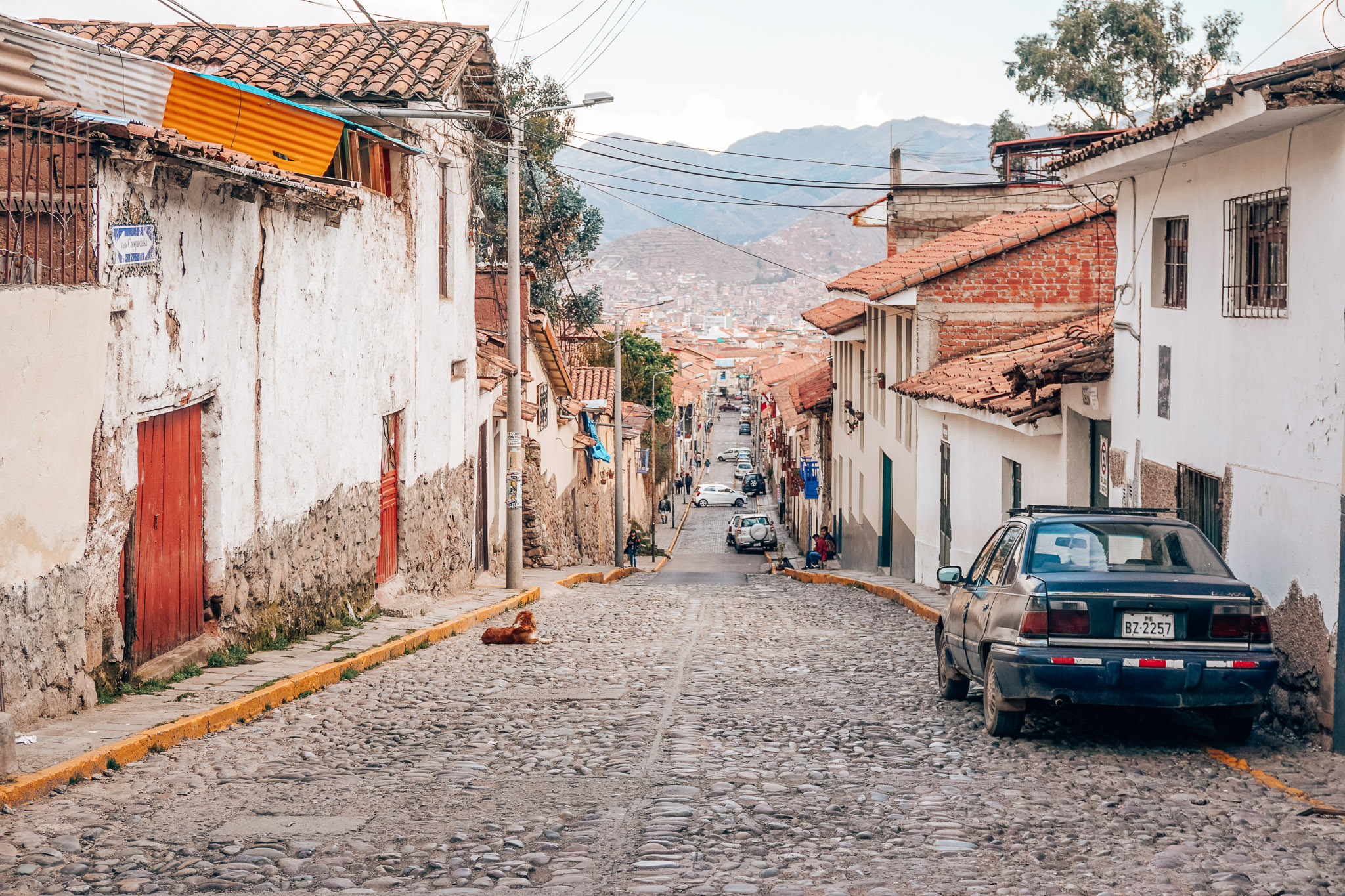 Woman strolling through quaint alleyway in charming Cusco, Peru